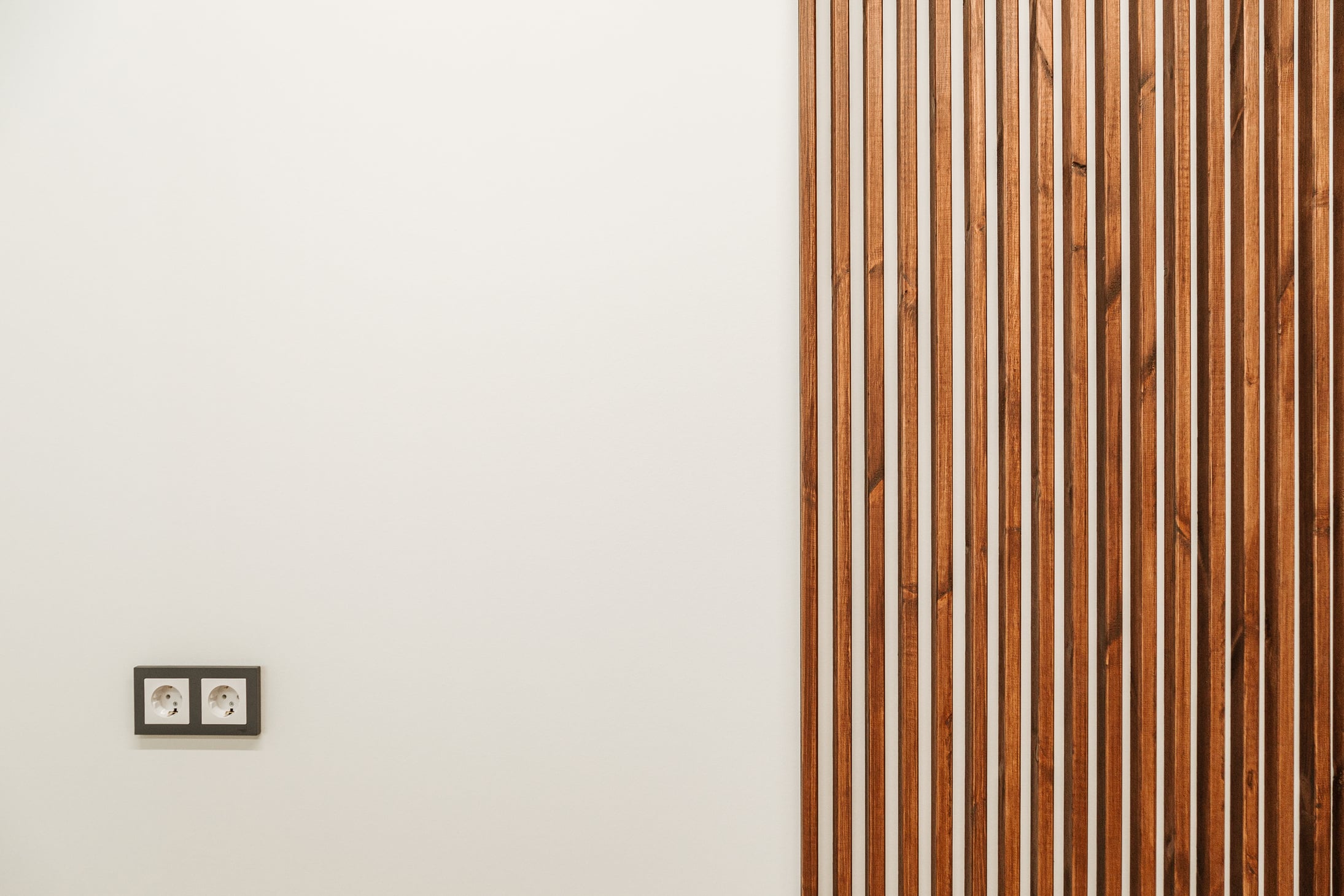 white wall with wooden brown slats